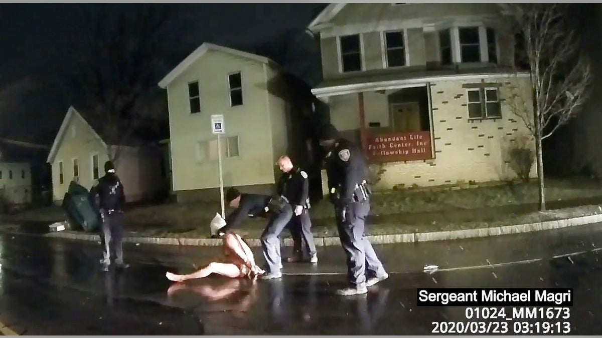 FILE - In this image from police body camera video provided by Roth and Roth LLP on Sept. 2, 2020, a Rochester police officer puts a spit hood over the head of Daniel Prude, on March 23, 2020, in Rochester, N.Y., after cops say Prude claimed to have the coronavirus.<br>
(Rochester Police via Roth and Roth LLP via AP)