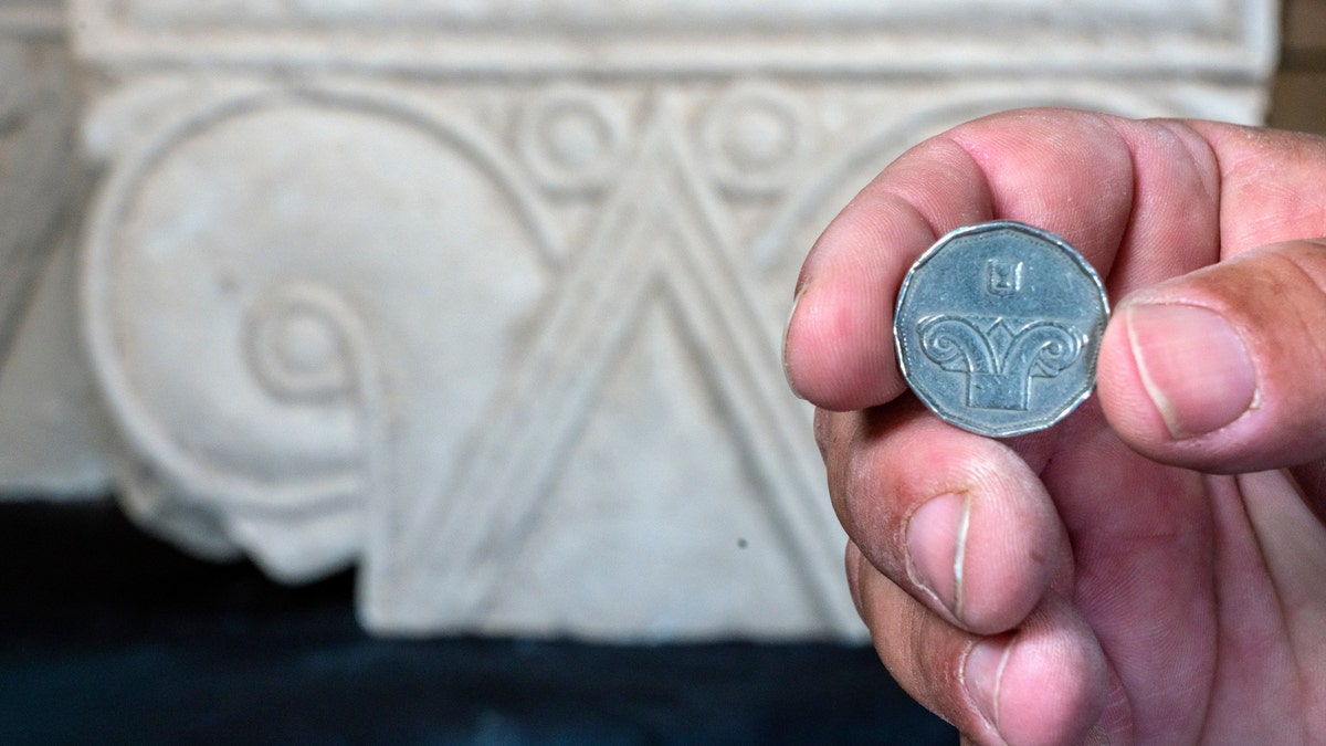 An Israeli five-shekel coin against the background of the capital discovered.