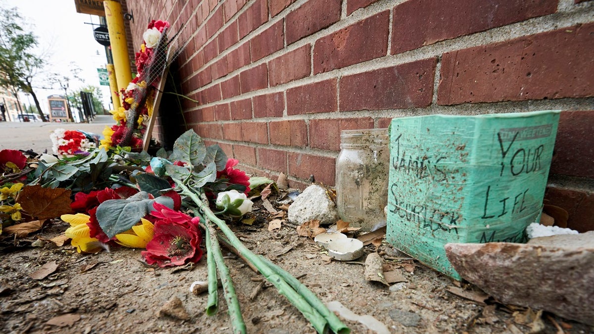 A memorial for James Scurlock remains on Wednesday near where he was shot and killed on May 30, in Omaha, Neb. A warrant is expected to be issued for the white bar owner who fatally shot him. AP Photo/Nati Harnik)