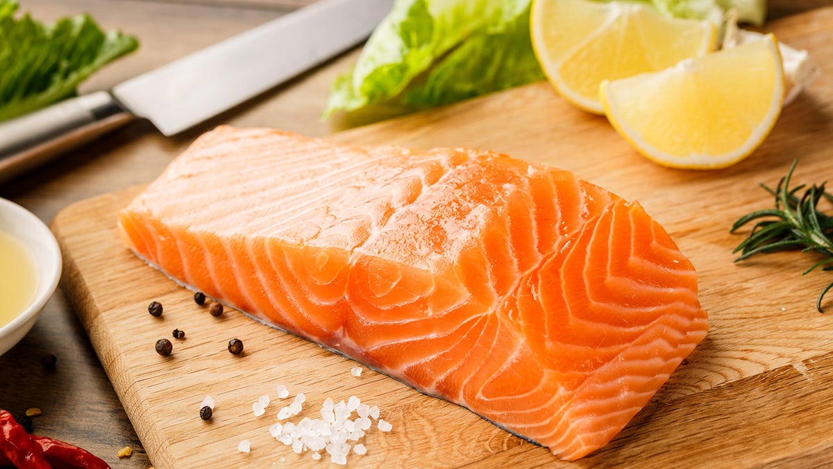 Salmon on a cutting board with lemon