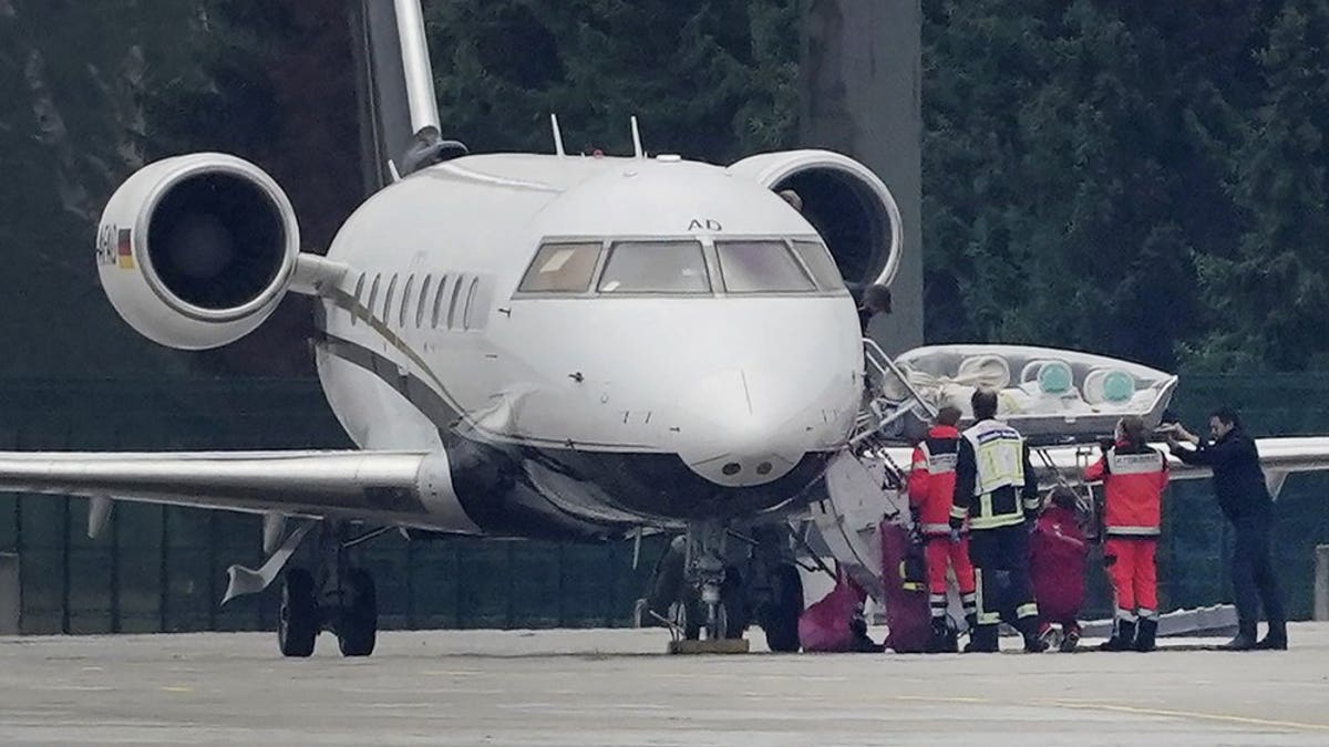 FILE-In this Aug. 22, 2020 file photo a stretcher is taken from special aircraft with the Kremlin critic Alexei Navalny on board at Tegel Airport in Berlin. Germany is increasing pressure on Russia over the poisoning of Russian opposition politician Alexei Navalny, warning that a lack of support by Moscow in the investigation could “force” Germany to rethink the fate of a German-Russian pipeline project. ( Michael Kappeler/dpa via AP)