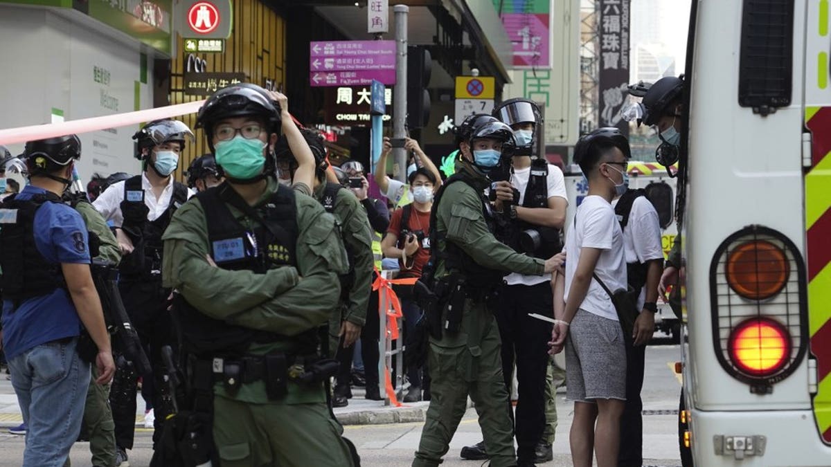A man is arrested by police officers at a downtown street in Hong Kong Sunday, Sept. 6, 2020. About 30 people were arrested Sunday at protests against the government's decision to postpone elections for Hong Kong's legislature, police and a news report said. (AP Photo/Vincent Yu)