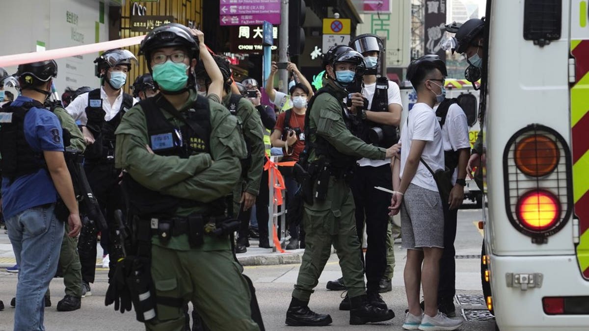A man is arrested by police officers at a downtown street in Hong Kong Sunday, Sept. 6, 2020. (AP Photo/Vincent Yu)