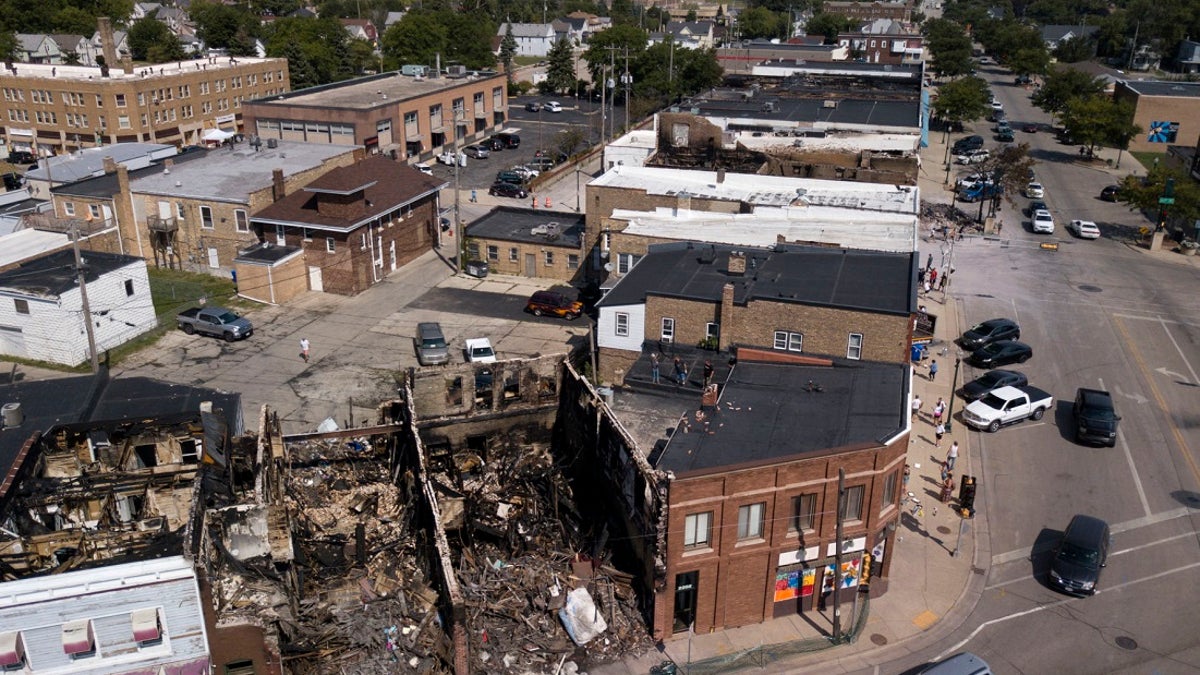 This Aug. 28, 2020 aerial photo shows damage to businesses in Kenosha, Wis. Police in Kenosha have arrested dozens of people since a white officer shot Jacob Blake in the back. (Sean Krajacic/The Kenosha News via AP)