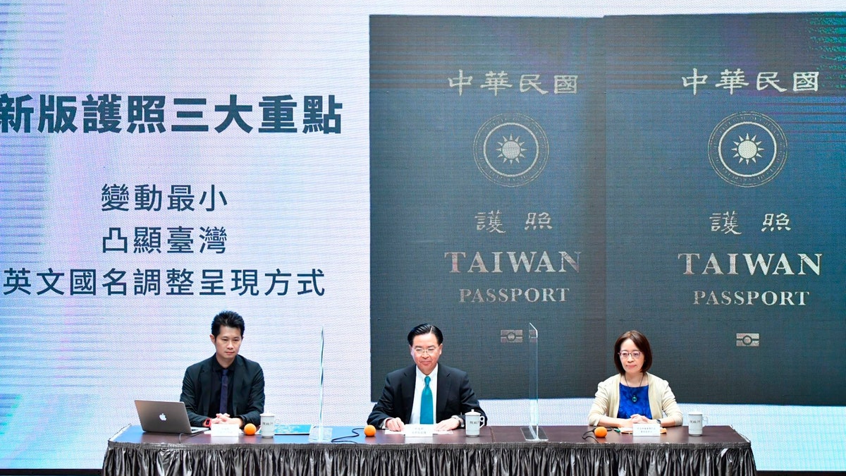 In this Sep. 2, 2020, photo released by the Executive Yuan, Taiwan's Foreign Minister Joseph Wu, center, and Executive Yuan spokesperson Evian Ting, left, and Director of Consular Affairs Bureau Phoebe Yeh attends a news conference to reveal the new Taiwan passport in Taipei, Taiwan. (Executive Yuan via AP)