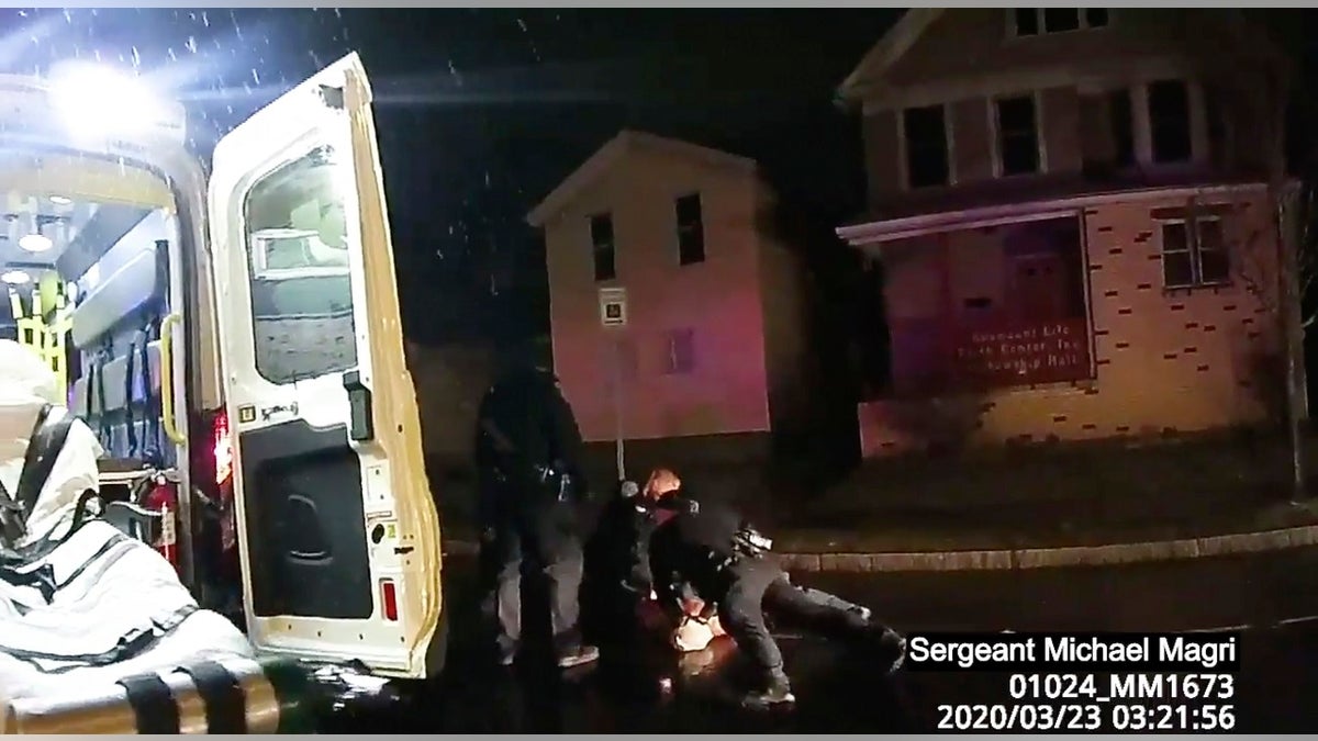 Rochester police officers hold down Daniel Prude on March 23 in Rochester, N.Y. Prude, a Black man who had run naked through the streets of the western New York city, died of asphyxiation after a group of police officers put a hood over his head, then pressed his face into the pavement for two minutes, according to video and records released Wednesday by the man's family. (Rochester Police via Roth and Roth LLP via AP)