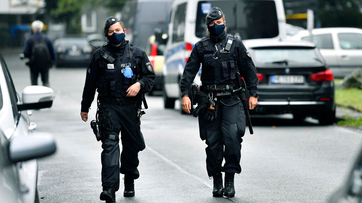 Police secure a street where five dead children were found in an apartment house in Solingen, Germany, Thursday, Sept. 3, 2020. (AP Photo/Martin Meissner)