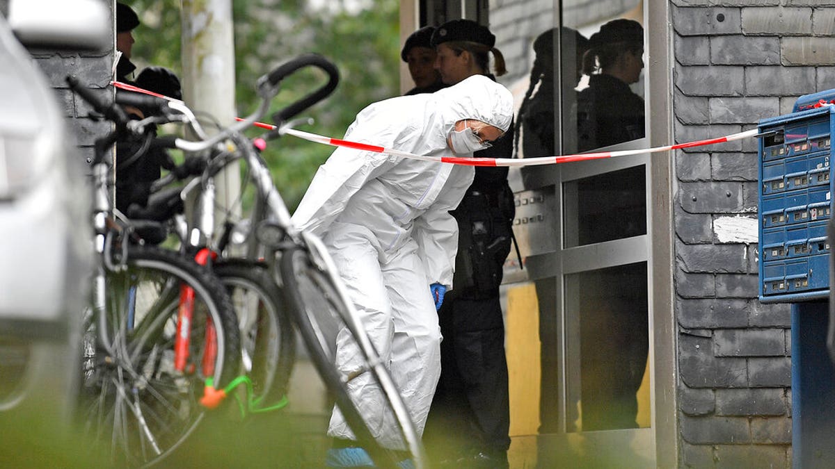 A forensic officer leaves a house, where five dead children were found in Solingen, Germany, Thursday, Sept. 3, 2020. Police say the five children have been found dead at an apartment in the western German city, and their mother is suspected of killing them. (AP Photo/Martin Meissner)