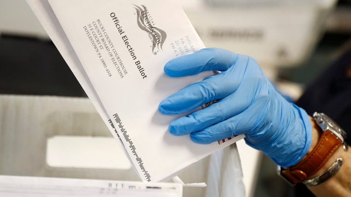 A worker processes mail-in ballots at the Bucks County Board of Elections office prior to the primary election in Doylestown, Pennsylvania, May 27, 2020.