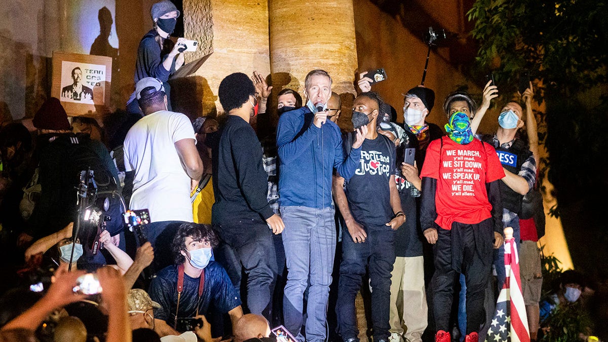 Portland Mayor Ted Wheeler speaks to Black Lives Matter protesters in Portland, Ore., in July. (Associated Press)