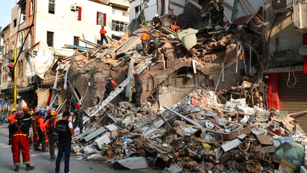 Chilean and Lebanese rescuers search in the rubble of a building that was collapsed in last month's massive explosion, after getting signals there may be a survivor under the rubble, in Beirut, Lebanon, Sept. 3.