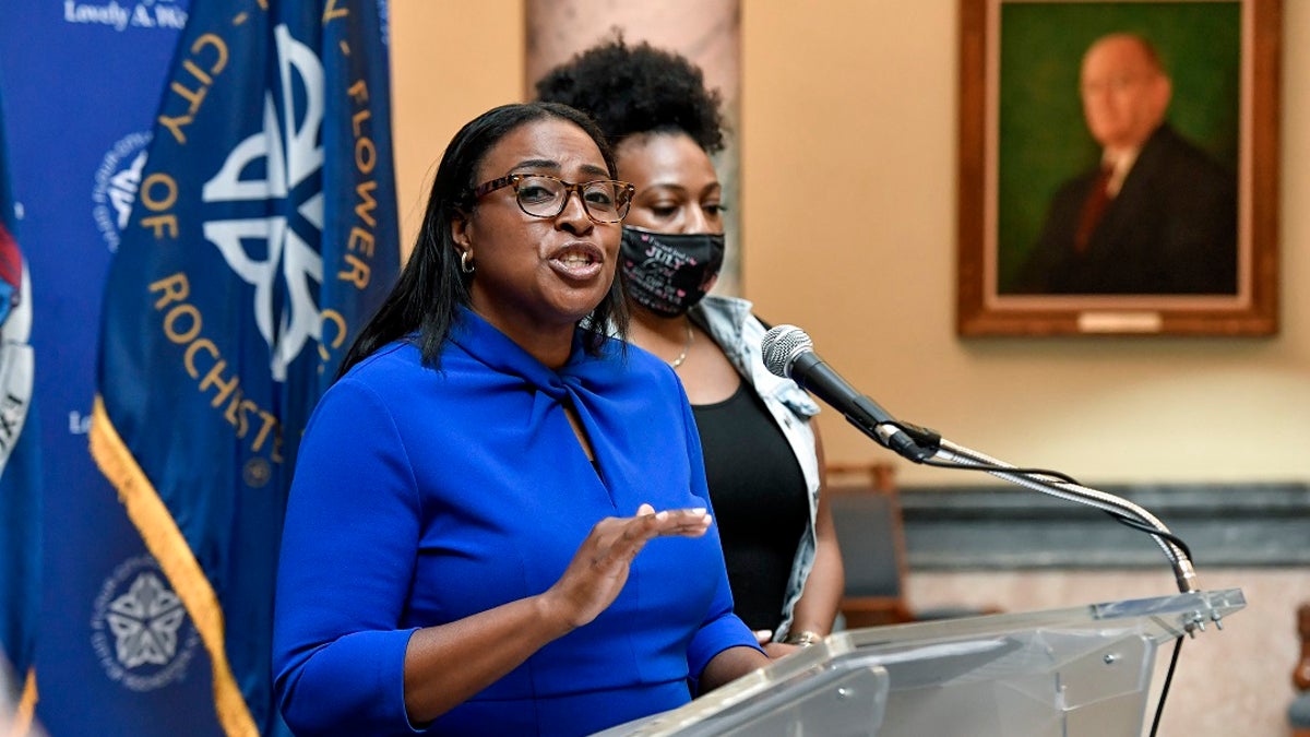 Rochester Mayor Lovely Warren, left, speaks to the media during a press conference in Rochester, N.Y., Thursday, Sept. 3, 2020. (AP Photo/Adrian Kraus)