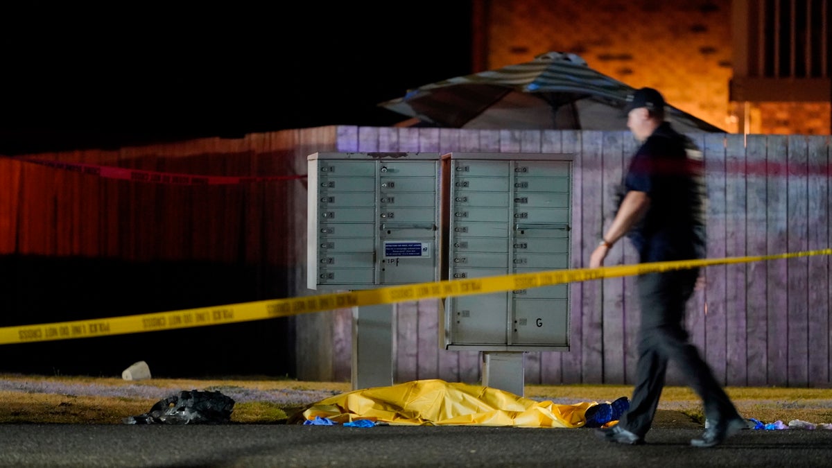 Officials work at the area late Thursday, Sept. 3, 2020, in Lacey Wash., where a man suspected of fatally shooting a supporter of a right-wing group in Portland, Ore. (AP Photo/Ted Warren)