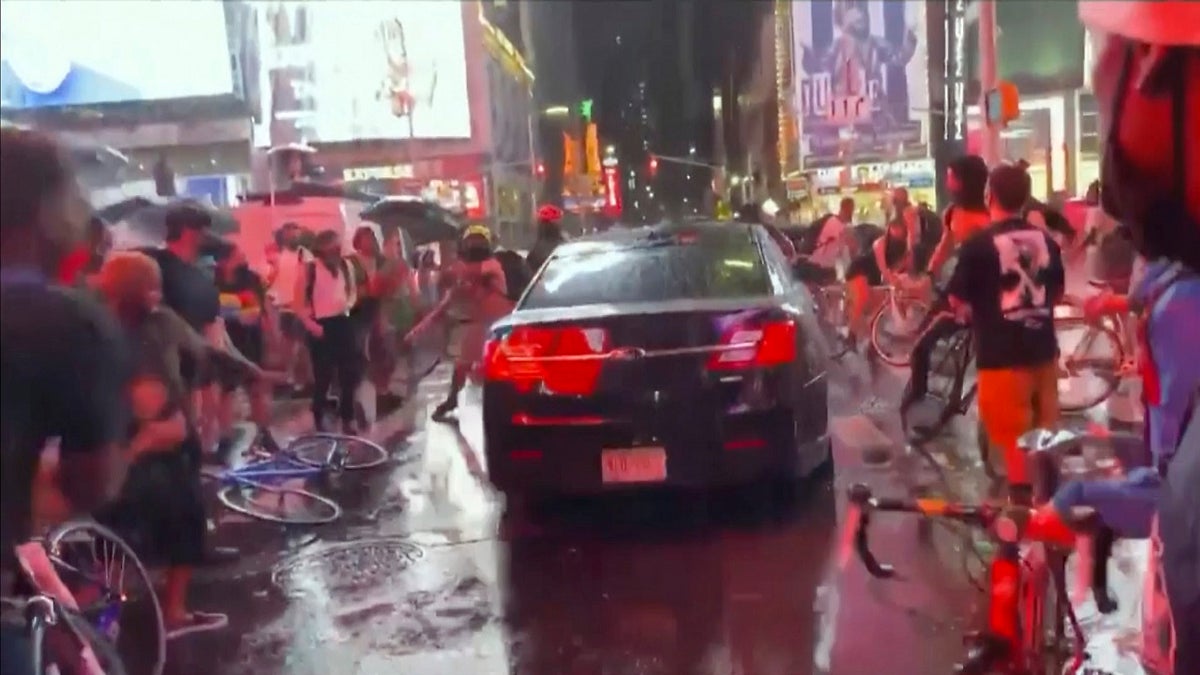 In this frame grab from a video by @datainput from the New York City Police Department Twitter account, a car moves through protesters, in New York's Times Square on Thursday. The New York Police Department says it is trying to find the car that drove through a group of Black Lives Matter protesters blocking a street in Times Square. (New York City Police Dept. via AP)