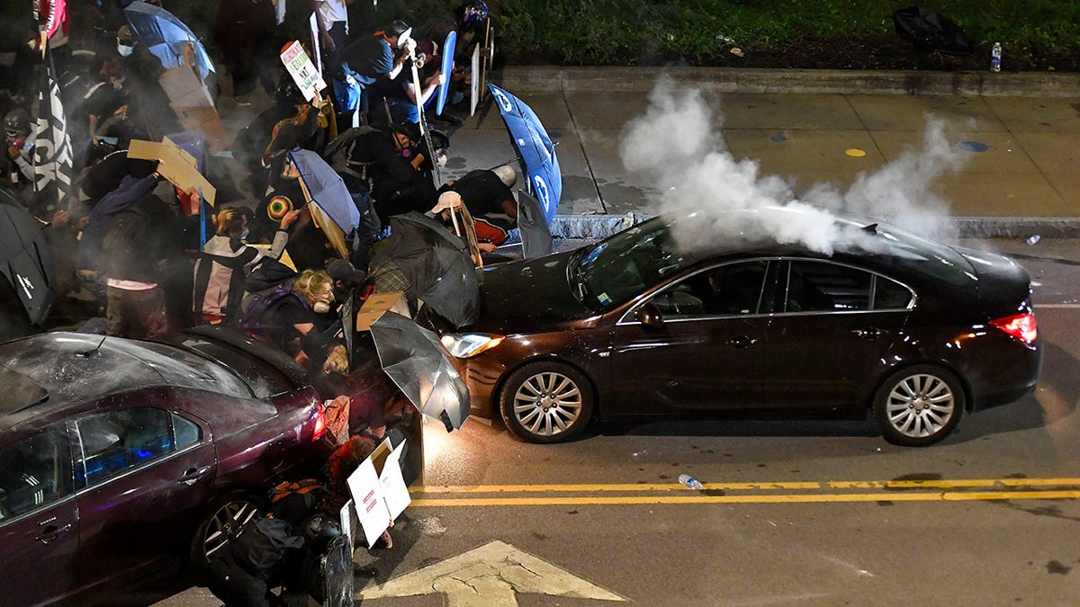 Demonstrators clash with police officers a block from the Public Safety Building in Rochester, N.Y., Sept. 4, 2020, after a rally and march protesting the death of Daniel Prude. (Associated Press)