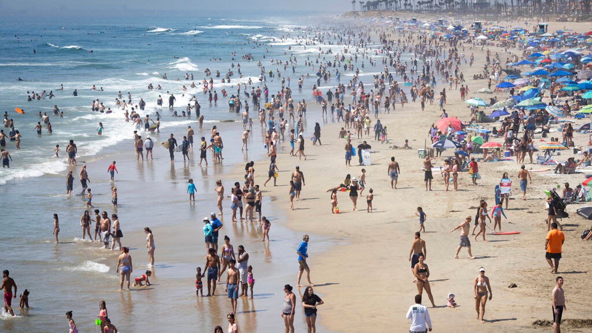 People are seen at the beach during a heat wave, Sunday, Sept. 6, 2020, in Huntington Beach, Calif. (AP Photo/Christian Monterrosa)