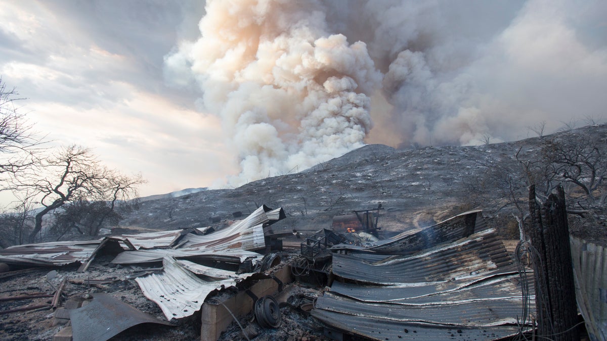 FILE - In this Saturday, Sept. 5, 2020, file photo, a burned structure is seen at a wildfire in Yucaipa, Calif. A couple’s plan to reveal their baby’s gender at a party went up in smoke Saturday at El Rancho Dorado Park in Yucaipa, when a pyrotechnical device they used sparked a wildfire that has burned thousands of acres. (AP Photo/Ringo H.W. Chiu, File)