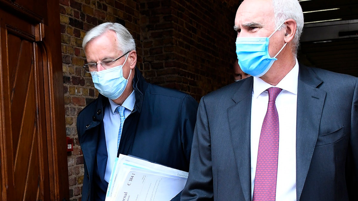 EU Chief negotiator Michel Barnier, left, arrives at St. Pancras international train station in London, Wednesday, Sept. 9, 2020. UK and EU officials begin the eighth round of Brexit negotiations in London. (AP Photo/Alberto Pezzali)
