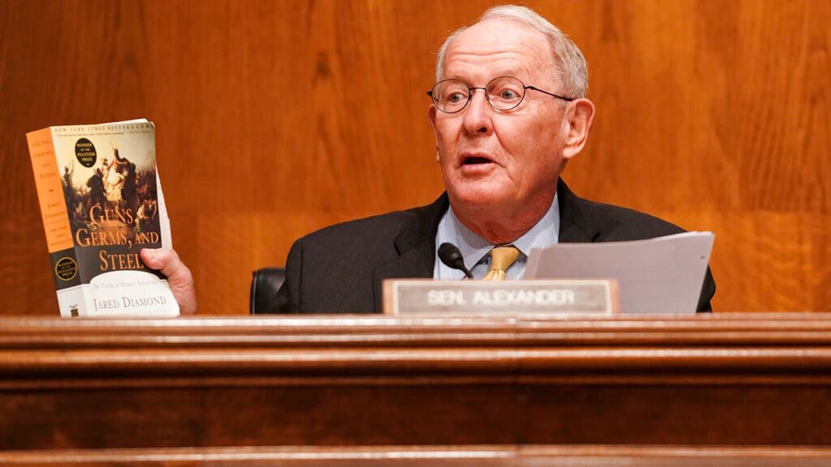 Senate Health, Education, Labor, and Pensions Committee Chairman Lamar Alexander, R-Tenn., holds up a copy of "Guns, Germs, and Steel" by Jared Diamond.