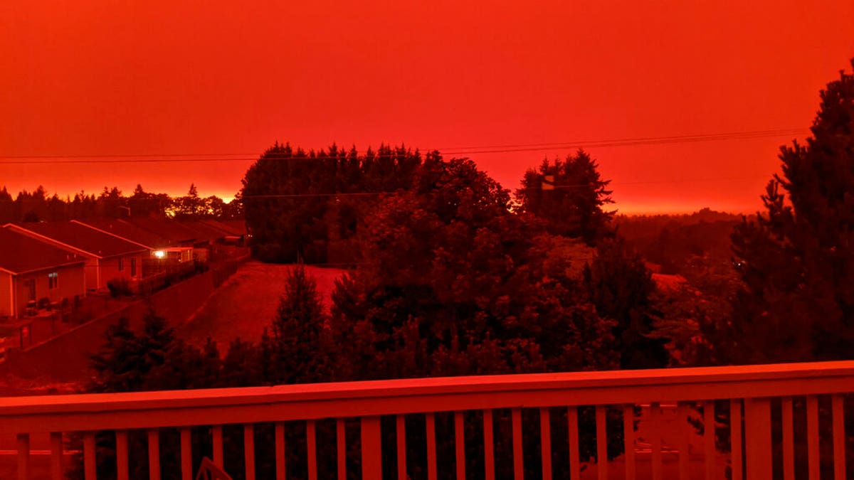 This photo taken from the home of Russ Casler in Salem, Ore., shows the smoke-darkened sky well before sunset at around 5 p.m., Tuesday, Sept. 8, 2020. Strong winds and high temperatures continued to fuel catastrophic fires in many parts of Oregon on Wednesday, forcing thousands of people to flee from their homes and making for poor air quality throughout the West. Huge wildfires also continued to grow in neighboring Washington state. (Russ Casler via AP)