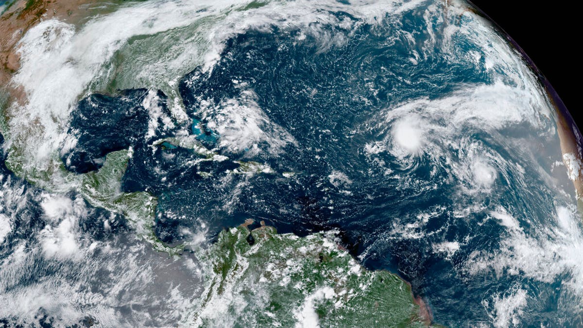 This GOES-16 GeoColor satellite image taken Thursday, Sept. 10, 2020, and provided by NOAA, shows tropical storms forming in the Atlantic. La Nina, which often means a busier Atlantic hurricane season, a drier Southwest and perhaps a more fire-prone California, has popped up in the Pacific Ocean, the National Oceanic and Atmospheric Administration announced Thursday, Sept. 10. (NOAA via AP)