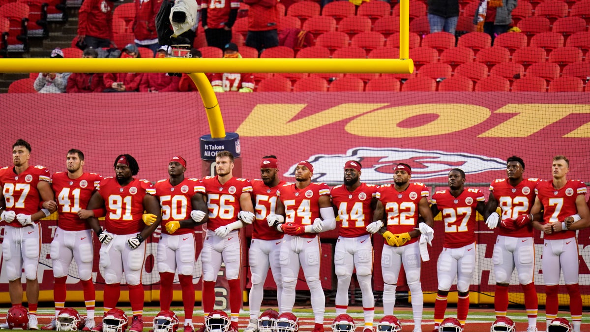 Kansas City Chiefs players stand for a presentation on social justice before an NFL football game against the Houston Texans Thursday, Sept. 10, 2020, in Kansas City, Mo. (AP Photo/Charlie Riedel)