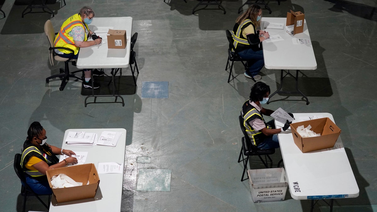 Workers prepare absentee ballots for mailing at the Wake County Board of Elections in Raleigh, N.C.