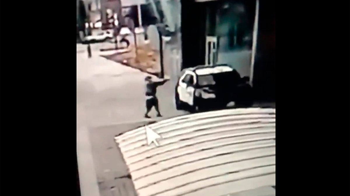 A screen grab from a security camera video released the Los Angeles County Sheriff's Department shows a gunman walking up to sheriff's deputies and opening fire without warning or provocation in Compton, Calif., on Saturday. (Los Angeles County Sheriff's Department via AP)