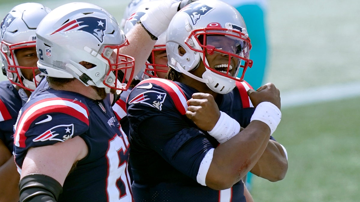 New England Patriots quarterback Cam Newton (1) celebrates his rushing touchdown against the Miami Dolphins with teammates in the first half of an NFL football game, Sunday, Sept. 13, 2020, in Foxborough, Mass. (AP Photo/Steven Senne)