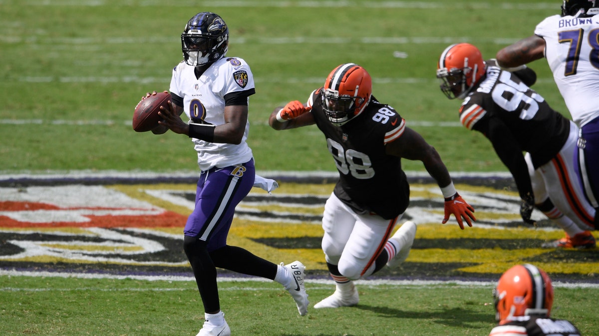 Baltimore Ravens quarterback Lamar Jackson (8) looks to pass as he is pursued by Cleveland Browns defensive tackle Sheldon Richardson (98), during the first half of an NFL football game, Sunday, Sept. 13, 2020, in Baltimore, MD. (AP Photo/Nick Wass)