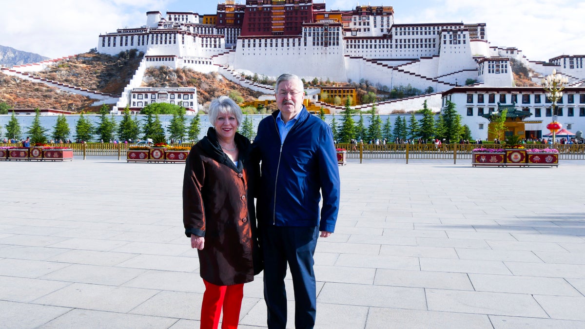 In this May 22, 2019 photo released by the U.S. Embassy in Beijing, U.S. Ambassador to China Terry Branstad and his wife Christine pose for a photo in front of the Potala Palace in Lhasa in western China's Tibet Autonomous Region. (U.S. Mission to China via AP, File)