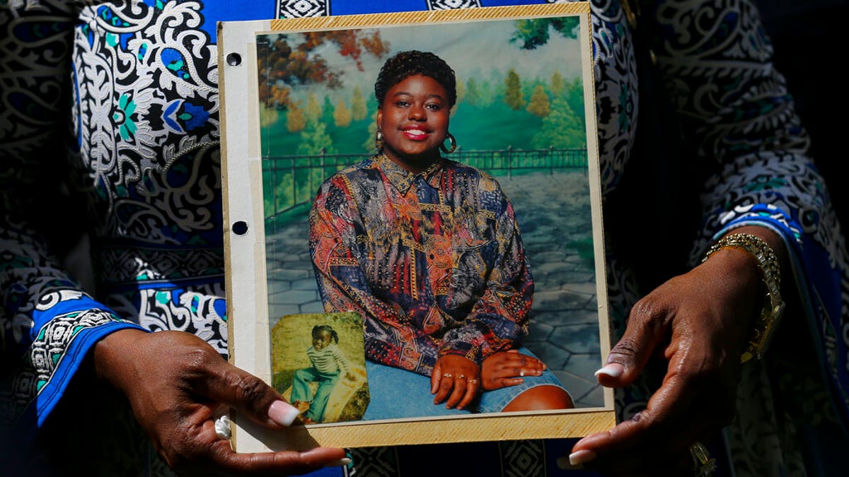 FILE: Antoinette Dorsey-James holds a picture of her sister Pamela Turner during a news conference outside the Harris County Civil Court in Houston.