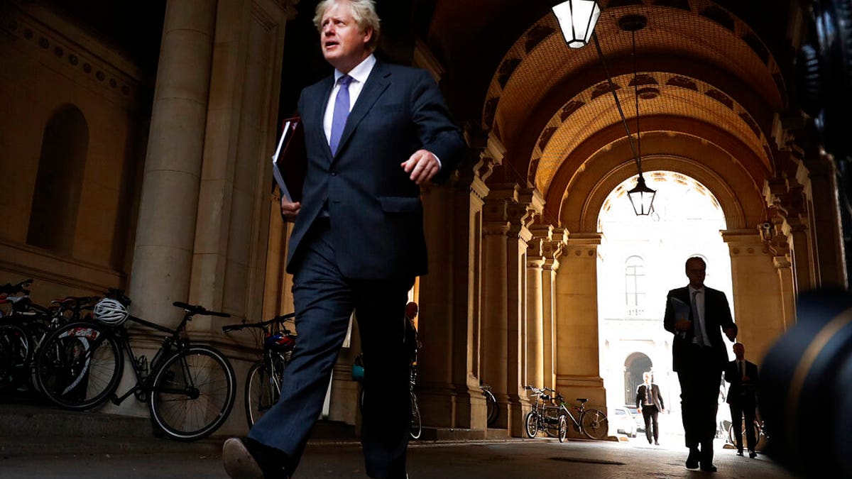 Britain's Prime Minister Boris Johnson walks to his office in Downing Street after a cabinet meeting in London, Tuesday, Sept. 15, 2020.(AP Photo/Frank Augstein)