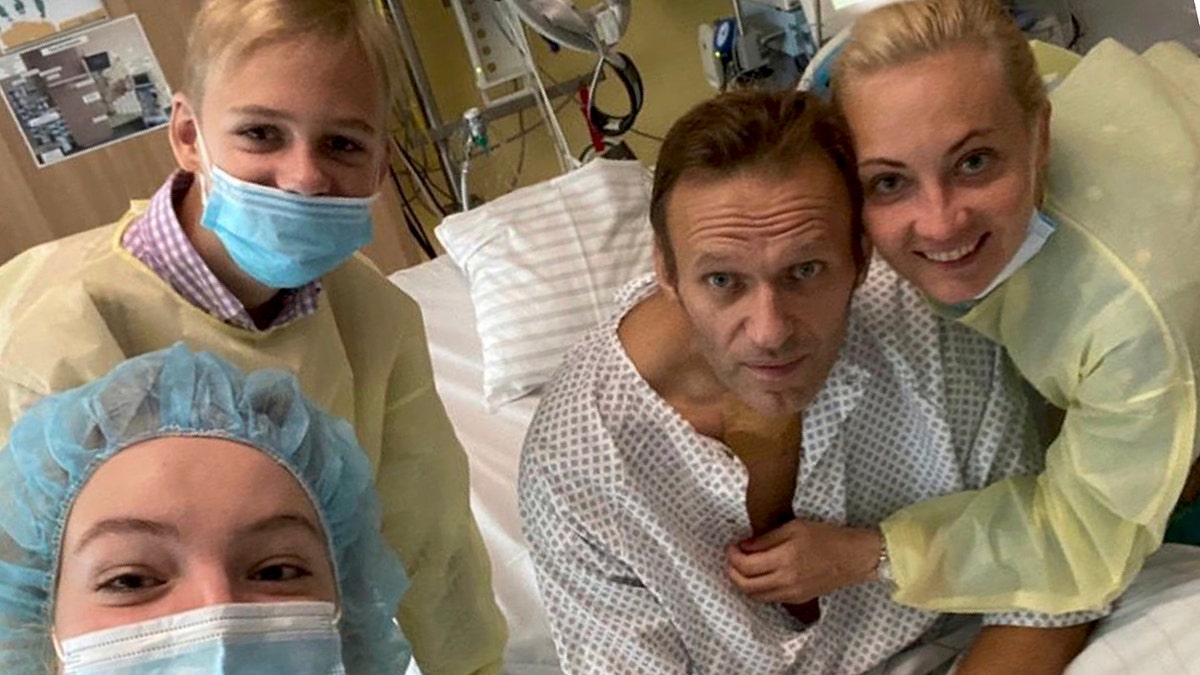 This handout photo, published by Russian opposition leader Alexei Navalny on his instagram account, shows himself, center, and his wife Yulia, right, posing for a photo with medical workers in a hospital in Berlin, Germany. He posted on Instagram Tuesday Sept. 15, 2020: "Hi, this is Navalny. I have been missing you. I still can't do much, but yesterday I managed to breathe on my own for the entire day." (Navalny instagram via AP)