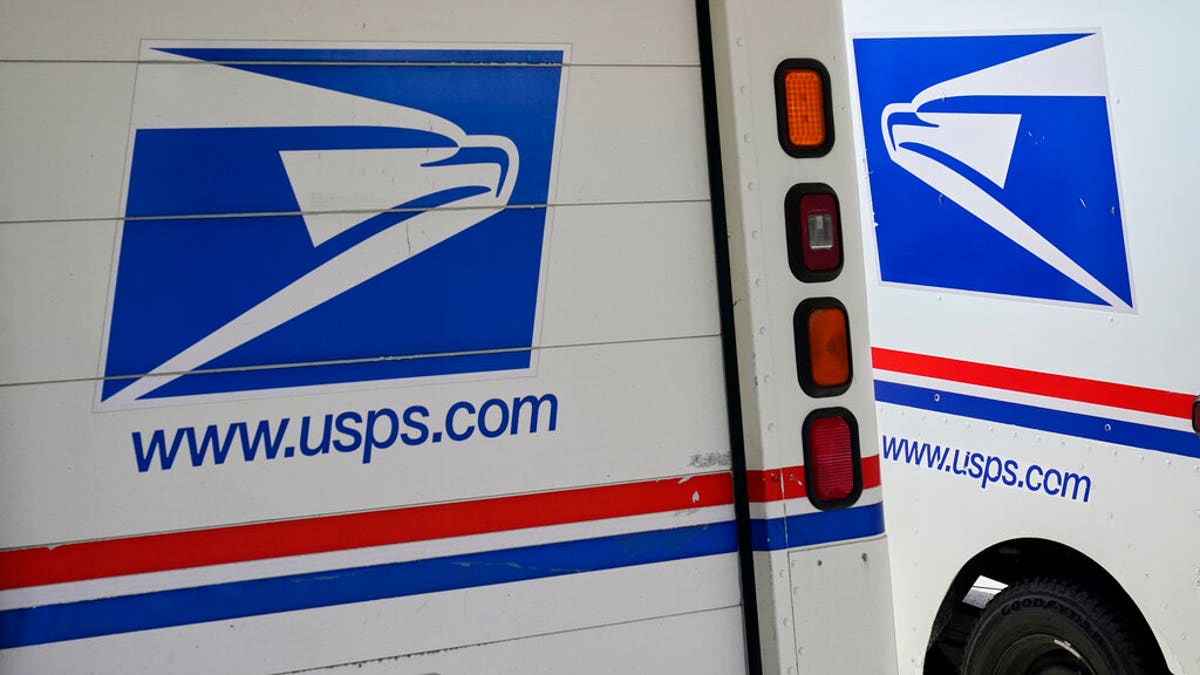 FILE: Mail delivery vehicles are parked outside a post office in Boys Town, Neb. 