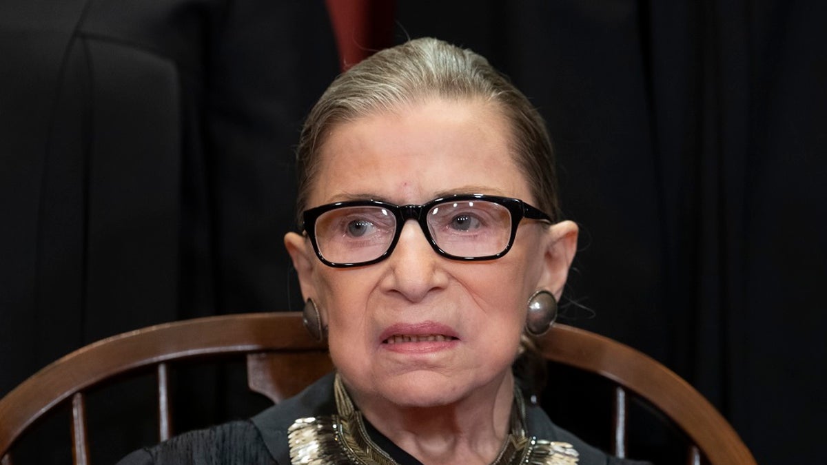 Associate Justice Ruth Bader Ginsburg, nominated by President Bill Clinton, sits with fellow Supreme Court justices for a group portrait at the Supreme Court Building in Washington, Friday. (AP Photo/J. Scott Applewhite, File)