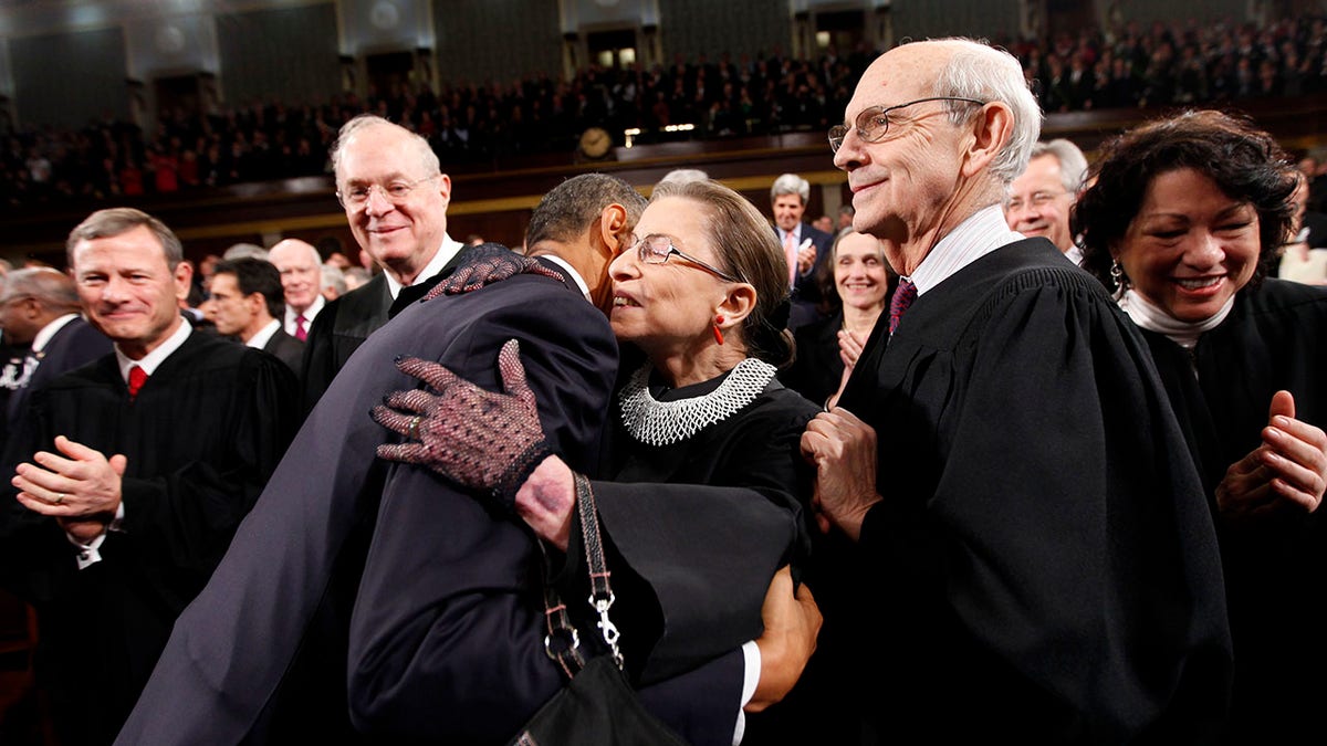 Then-President Barack Obama hugs Supreme Court Justice Ruth Bader Ginsburg on Capitol Hill in Washington, prior to his State of the Union address, Jan. 25, 2011. From left are Chief Justice John Roberts, Justice Anthony Kennedy, Obama, Justice Ginsburg and Justice Stephen Breyer. (Associated Press)