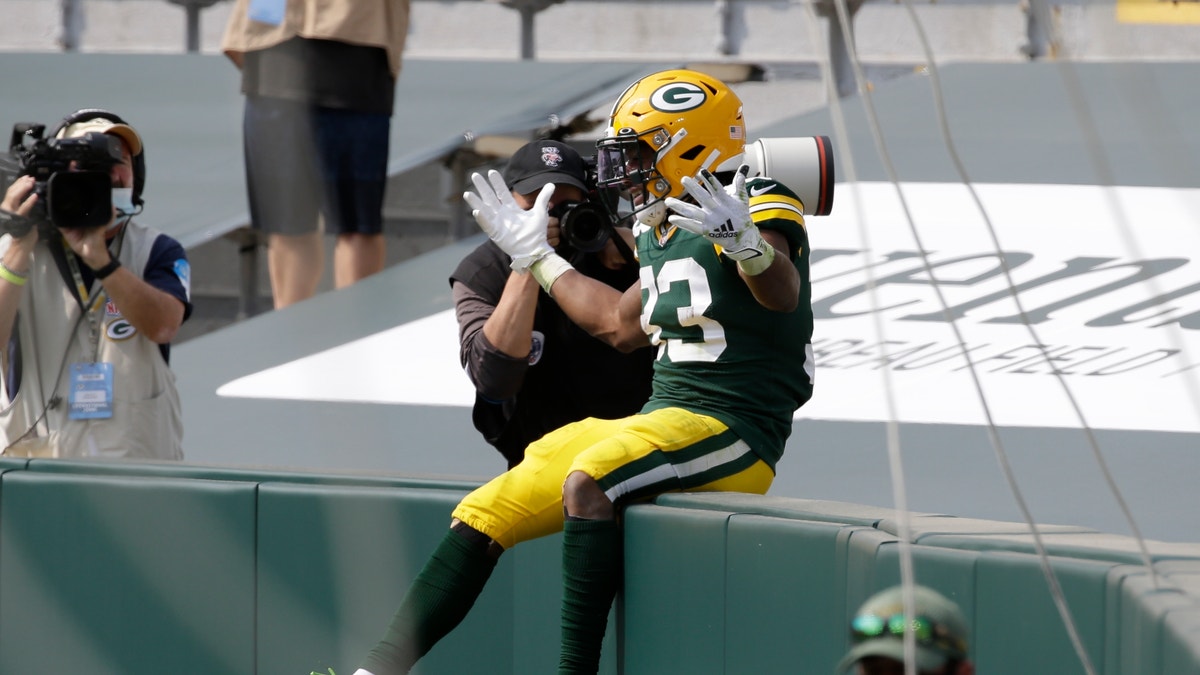 Green Bay Packers' Aaron Jones celebrates his touchdown catch during the first half of an NFL football game against the Detroit Lions Sunday, Sept. 20, 2020, in Green Bay, Wis. (AP Photo/Mike Roemer)