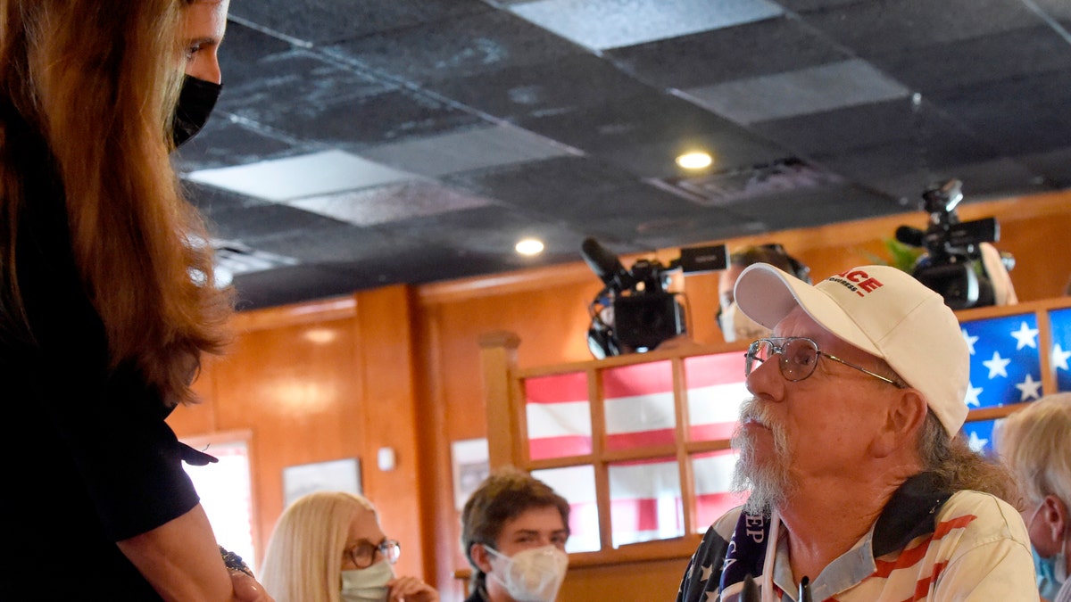 Republican congressional candidate and South Carolina state Rep. Nancy Mace, left, speaks with supporter Billy Paul, right, during a campaign event on Monday, Sept. 21, 2020, in North Charleston, S.C. (AP Photo/Meg Kinnard)