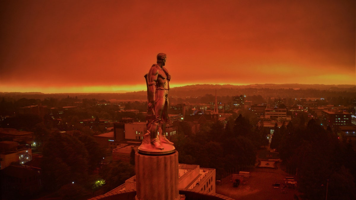 This drone photo provided by Michael Mann shows the Oregon Capitol building, with its "Oregon Pioneer" bronze sculpture atop the dome, as smoke and ash from nearby wildfires cloud skies in Salem, Ore., on Sept. 8, 2020. (Michael Mann via AP)