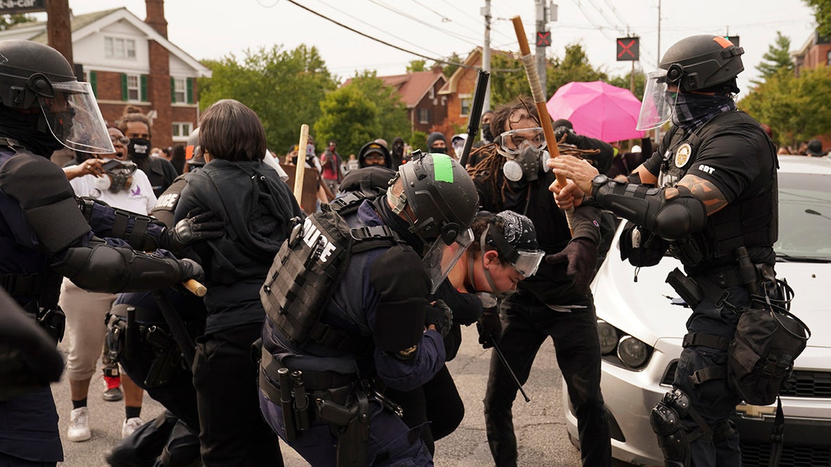 Police and protesters converge, Wednesday, Sept. 23, 2020, in Louisville, Ky. (AP Photo/John Minchillo)