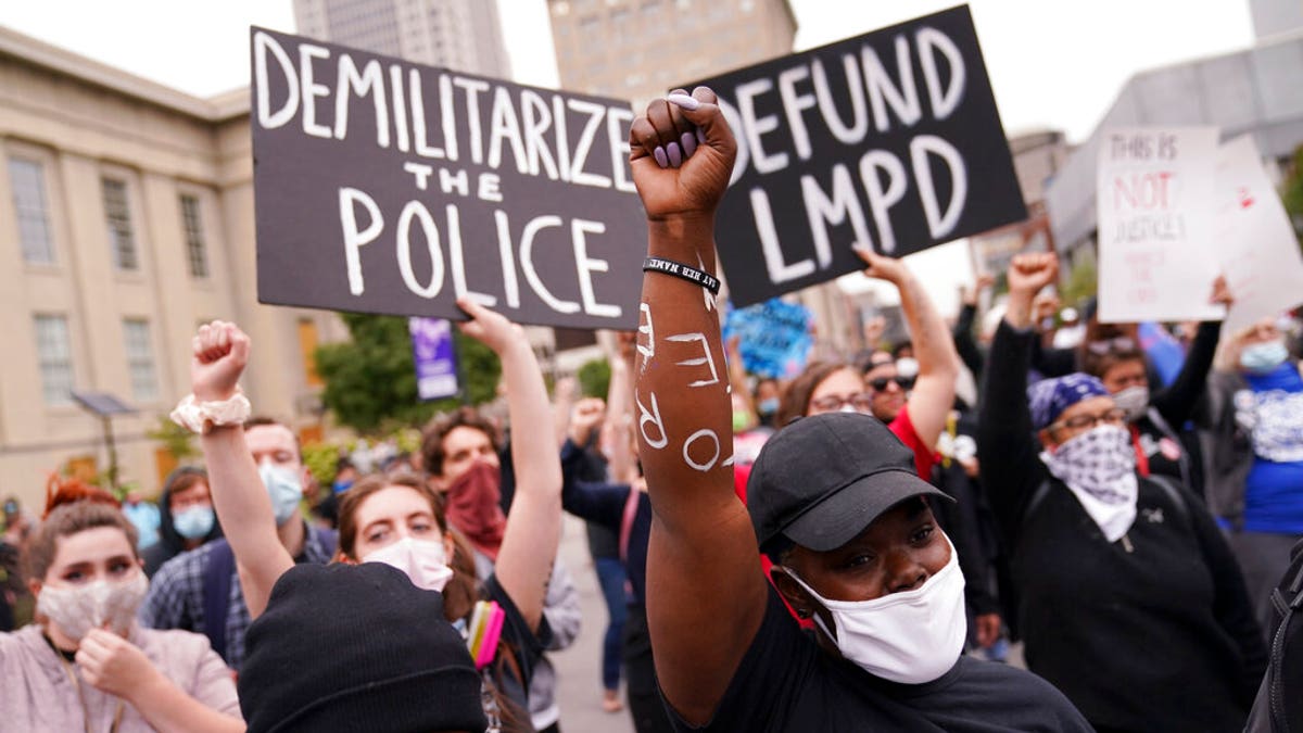 Protesters speak, Wednesday, Sept. 23, 2020, in Louisville, Ky. A grand jury has indicted one officer on criminal charges six months after Breonna Taylor was fatally shot by police in Kentucky. The jury presented its decision against fired officer Brett Hankison Wednesday to a judge in Louisville, where the shooting took place. (AP Photo/John Minchillo)