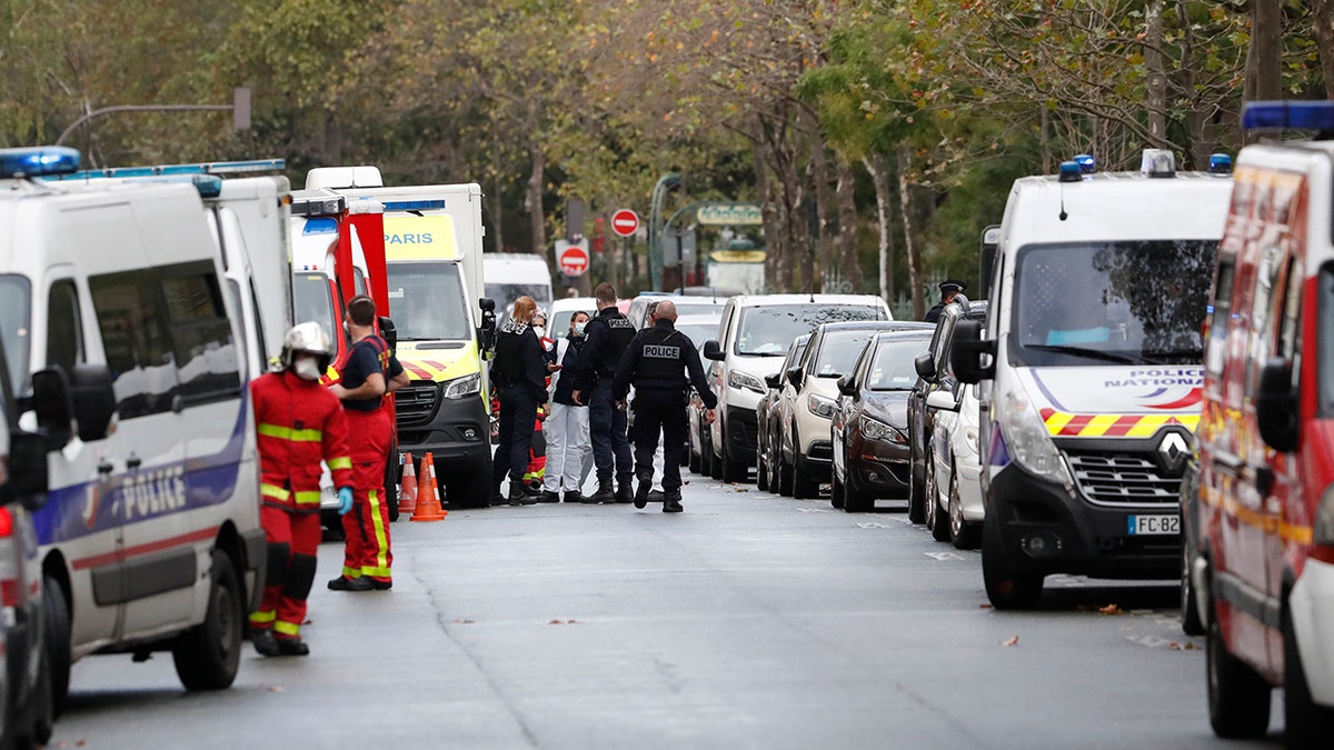 French police officers and rescue workers gather after four people have been wounded in a knife attack near the former offices of satirical newspaper Charlie Hebdo, Friday Sept. 25, 2020 in Paris. (AP Photo/Thibault Camus)