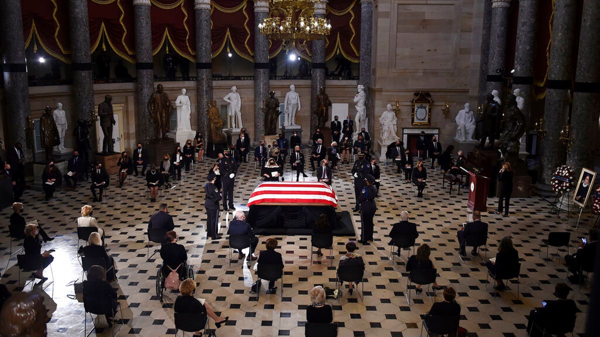 A U.S. Capitol Police honor guard surrounds the flag-draped casket of Justice Ruth Bader Ginsburg as lies in state in Statuary Hall of the U.S. Capitol, Friday, Sept. 25, 2020, in Washington. (Olivier Douliery/Pool via AP)