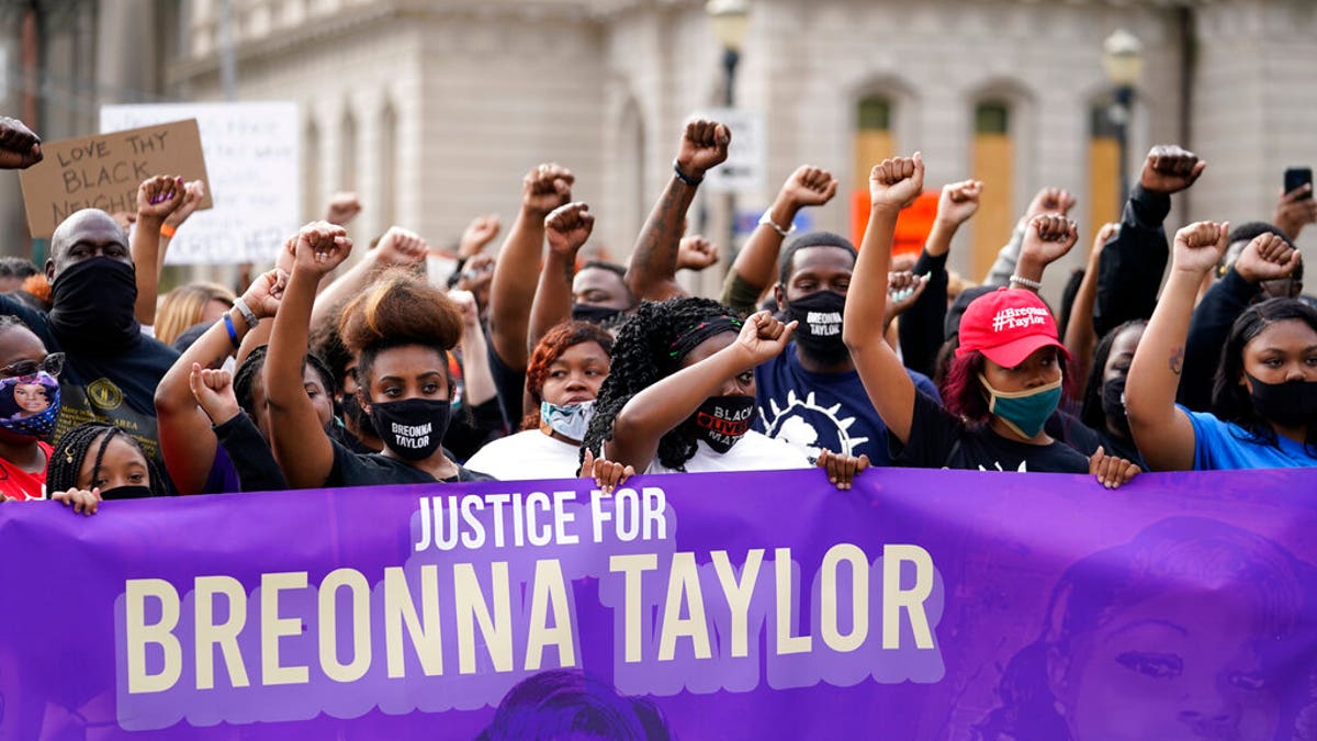 Black Lives Matter protesters march, Friday, Sept. 25, 2020, in Louisville. Breonna Taylor's family demanded Friday that Kentucky authorities release all body camera footage, police files and the transcripts of the grand jury hearings that led to no charges against police officers who killed the Black woman during a March drug raid at her apartment. (AP Photo/Darron Cummings)
