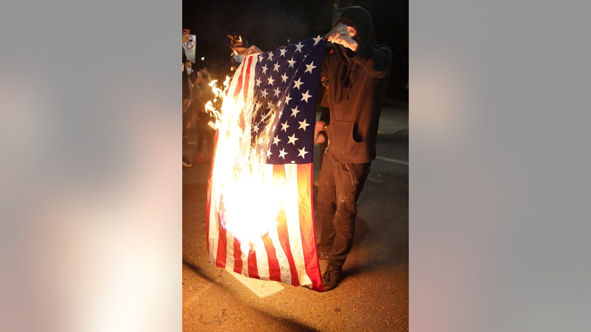 Protester in Portland seen burning the American flag in September of 2020