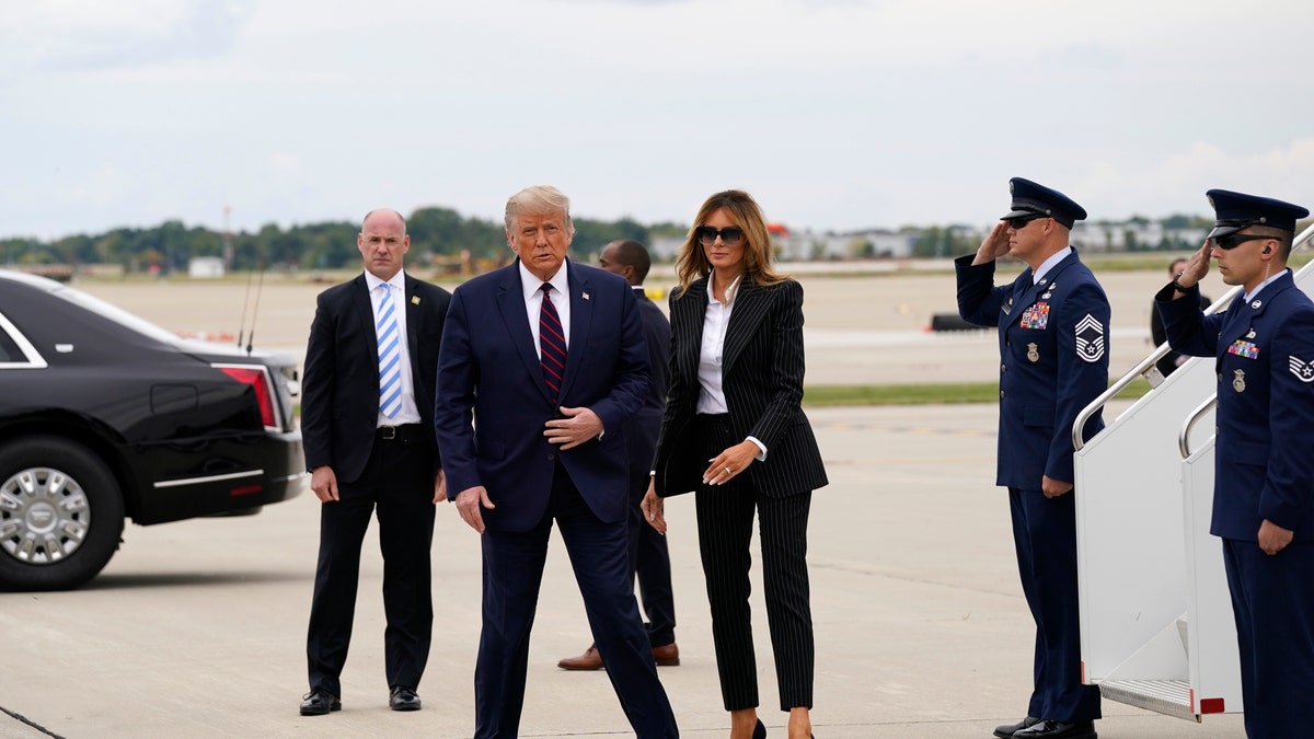 President Donald Trump and first lady Melania Trump arrive at Cleveland Hopkins International Airport for the first presidential debate, Tuesday, Sept. 29, 2020, in Cleveland. (AP Photo/Evan Vucci)