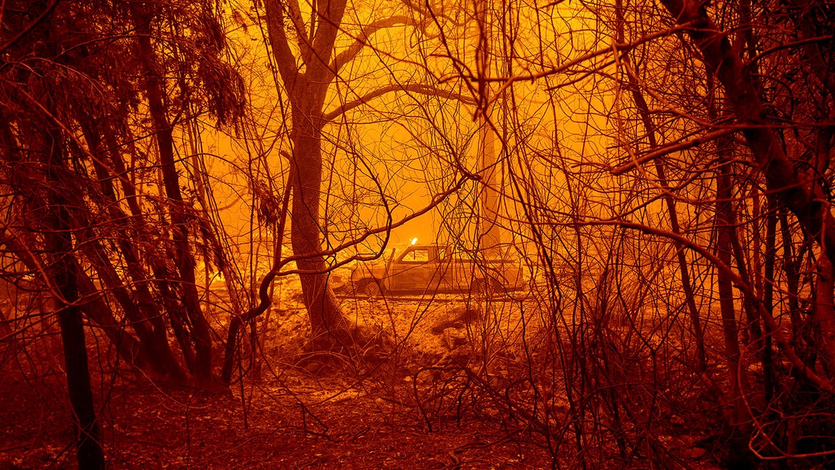 A scorched car rests in a clearing following the Bear Fire in Butte County, Calif., on Wednesday, Sept. 9, 2020.