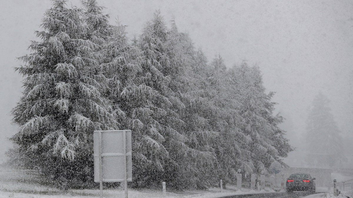 A car makes his way through heavy snow on motorway A 13 in Noesslach near Innsbruck, Austria, Friday, Sept. 25, 2020.