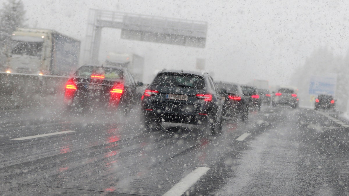 Cars make their way through heavy snow on motorway A 13 in Noesslach near Innsbruck, Austria, Friday, Sept. 25, 2020.